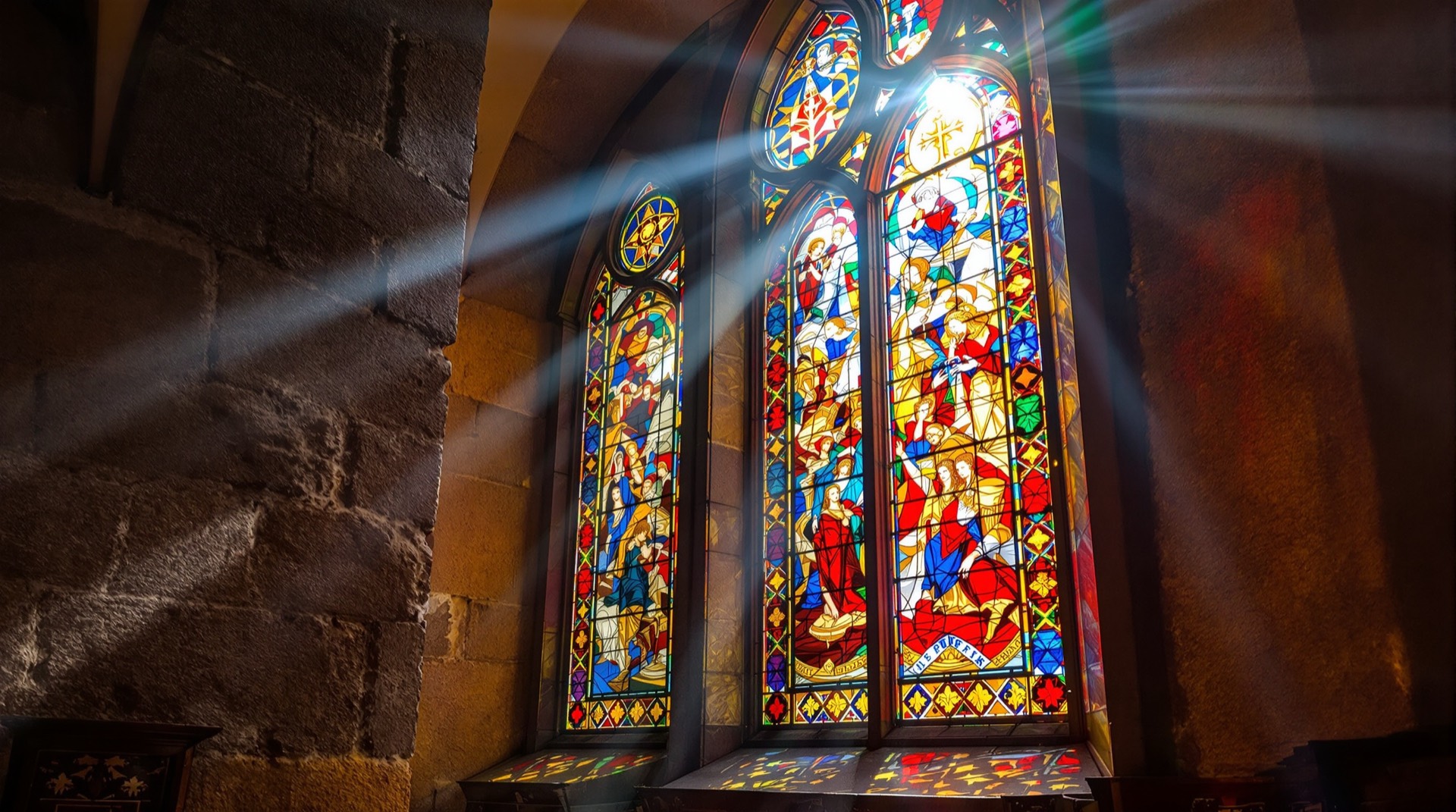 Antique stained-glass window glowing with red, gold, and blue light